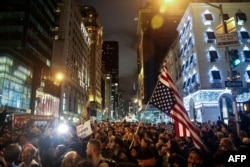 Protesters flood Fifth Avenue as they rally against Donald Trump outside Trump Tower in New York City, Nov. 9, 2016.