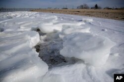Chunks of ice forms along the shore of the Raritan Bay in the northern part of the New Jersey Shore, Jan. 3, 2018, in Keansburg, New Jersey.