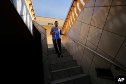 Carlos Junior leaves his home to watch a live broadcast of the match between Brazil and Mexico during the 2018 soccer World Cup, in Sao Paulo, July 2, 2018.
