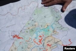 FILE - Managing Partner of CM Mining Dale Murray explains property leases on an active coal mine located next to a new solar power plant development site in Hurley, western Virginia, May 11, 2021.