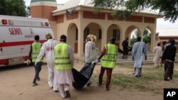 Rescue workers remove a body after a suicide attack at a camp of people displaced by Islamist extremist in Maiduguri, Nigeria, July 24, 2017. Female suicide bombers attacked two displaced persons camps in northeastern Nigeria's main city.