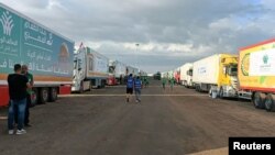 Trucks carrying humanitarian aid wait for the reopening of the Rafah crossing on the Egyptian side so they can enter Gaza amid the ongoing conflict between Israel and Hamas, in Rafah, Egypt, on Oct. 17, 2023.