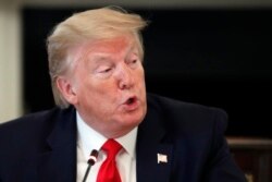 President Donald Trump speaks about reopening the country, during a roundtable with industry executives, in the State Dinning Room of the White House, April 29, 2020, in Washington.