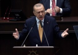 Turkey's President Recep Tayyip Erdogan addresses his ruling party lawmakers at the parliament, in Ankara, Turkey, Oct. 28, 2020.