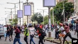 FILE - Protesters disperse as police deploy in Maputo, Nov. 7, 2024. Protesters dispute the outcome of Oct. 9 elections, which saw the ruling Frelimo party extend its 49-year rule.