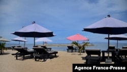 FILE - Empty deck chairs as seen by the beach in Sanur, near Denpasar on Indonesia's resort island of Bali on Oct. 14, 2021