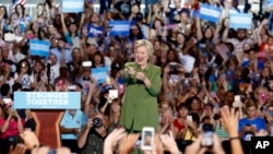 FILE - Democratic presidential candidate Hillary Clinton gestures at the audience as he arrives at a campaign event at the Florida State Fairgrounds Entertainment Hall in Tampa, Florida, July 22, 2016.