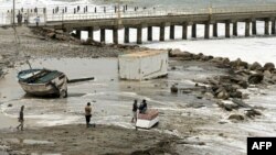 A fishing boat remains stranded after strong waves hit in Lobitos, Talara Province, Peru, Dec. 27, 2024.