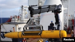 Crew aboard the Australian Defense Vessel Ocean Shield move the U.S. Navy's Bluefin-21 autonomous underwater vehicle into position for deployment in the southern Indian Ocean to look for the missing Malaysia Airlines flight MH370, April 14, 2014.