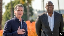 California Governor Gavin Newsom, left, has announced a new private sector initiative called LA Rises to be co-chaired by basketball legend Earvin "Magic" Johnson, and aimed at supporting rebuilding efforts after the devastating wildfires in Los Angeles, Jan. 28, 2025.