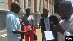 Zimbabwe journalists outside the Constitutional Court after it struck off defamation in the southern African country, Feb. 3, 2016. (Sebastian Mhofu/VOA)