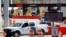 FILE - A U.S. Customs and Border Protection vehicle stands beside a sign reading that the border is closed to nonessential traffic, at the Canada-United States border crossing at the Thousand Islands Bridge, in Lansdowne, Ontario, Sept. 28, 2020. 