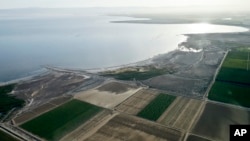 In this May 1, 2015, aerial photo, exposed lake bed of the Salton Sea dries out near Niland, California.