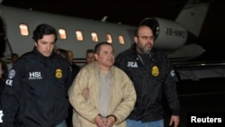 Mexico's top drug lord Joaquin "El Chapo" Guzman is escorted as he arrives at Long Island MacArthur airport in New York, Jan. 19, 2017, following his extradition from Mexico.
