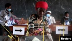 FILE - A voter casts her ballot in Ngozi, Burundi, May 20, 2020, amid concerns over political violence and COVID-19 infection.