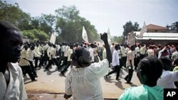 A southern Sudanese woman chants with pro-independence activists as they march through the southern capital of Juba on 09 Sep 2010.