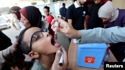 A Palestinian child is vaccinated against polio, amid the Israel-Hamas conflict, in Deir Al-Balah in the central Gaza Strip, Oct. 14, 2024.