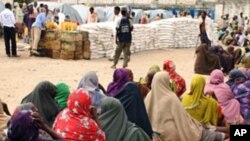 Internally displaced Somali women queue to receive food-aid rations at a distribution center, in an IDP camp in the Somali capital Mogadishu, July 26, 2011