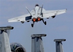 FILE PHOTO - A U.S. Navy F/A-18 Super Hornet takes off from the flight deck of the USS George Washington during 'Keen Sword' U.S.-Japan joint military exercise over the Pacific Ocean.