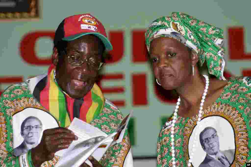 President Robert Mugabe talks to his wife Grace, at the launch of his party's manifesto and campaign in Harare, Feb. 29, 2008.