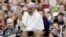 Pope Francis acknowledges faithful as he parades on his way to celebrate Mass in Philadelphia, Sept. 27, 2015.