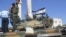 Members of the Free Syrian Army stand atop a tank in Azzaz, Aleppo province July 19, 2012. 