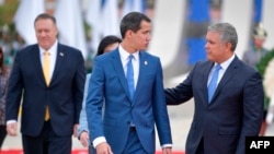 Colombian President Ivan Duque, right, speaks with Venezuelan opposition leader Juan Guaido as U.S. Secretary of State Mike Pompeo walks at left, in Bogota, Jan. 20, 2020.