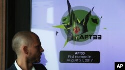 Alister Shepherd, the director of a subsidiary of the cybersecurity firm FireEye, gestures during a presentation about the APT33 hacking group.