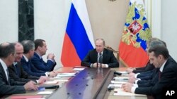 FILE - Russian President Vladimir Putin chairs a Security Council meeting in the Kremlin in Moscow, Russia, Jan. 13, 2017. Experts say Putin has made it his foreign policy goal to weaken America’s traditional links to its allies and to divide NATO.