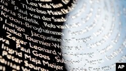 FILE - Names of the victims during the revealing of the National Monument for the MH17 in Vijfhuizen, The Netherlands, July 17, 2017. 