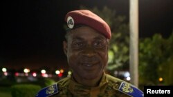 FILE - Head of Burkina Faso's presidential guard Gilbert Diendere waits for his chauffeur to arrive after the swearing-in ceremony of newly named President Michel Kafondo in Ouagadougou November 21, 2014.