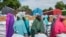 FILE- Women and villagers wait to receive food donations from the United Nations World Food Program in Damasak, northeastern Nigeria, Oct. 6, 2024.
