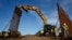 FILE - Construction crews install new border wall sections, Jan. 9, 2019, seen from Tijuana, Mexico. 