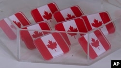 FILE - In this image made from video, Canadian flag pins are on display at the Whiskeyjack Boutique gift shop, March 4, 2025, in Windsor, Ontario. 