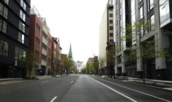 An empty street leads toward Dupont Circle, a popular neighborhood with lively dining and nightlife in Washington, DC, April 4, 2020. (Photo by Diaa Bekheet). DC is under a stay-at-home order due to coronavirus pandemic..