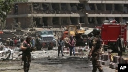 FILE - Security forces inspect the site of a massive suicide attack that killed more than 150, according to the Afghan president, in front of the German Embassy in Kabul, Afghanistan, May 31,2017. A letter by a senior Islamic State militant points to a growing power struggle within the group’s Afghan affiliate, pitting Uzbek fighters against Pakistanis.