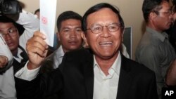 FILE - Opposition Cambodia National Rescue Party President Kem Sokha shows off his ballot before voting in local elections in Chak Angre Leu on the outskirts of Phnom Penh, Cambodia, June 4, 2017. 