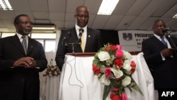 Malawi’s presidential aspirant in the May 20 tripartite elections and head of Malawi's United Democratic Front (UDF) party Atupele Muluzi (C) speaks next to his running mate Godfrey Chapola (L) and a Malawi Electoral Commission official (R) to present his nomination papers to the Commission, Feb. 12, 2014, Blantyre.