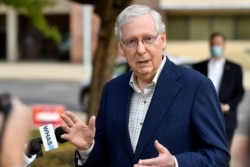 Senate Majority Leader Mitch McConnell, R-Ky., speaks to reporters after casting his vote in the 2020 general election at the Kentucky Exhibition Center in Louisville, Ky., Oct. 15, 2020.