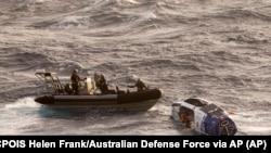 Navy sailors from HMAS Choules use an inflatable boat to rescue Lithuanian rower Aurimas Mockus, Monday, March 3, 2025
