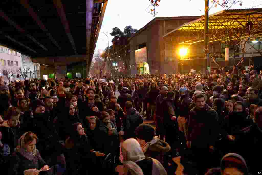 People gather for a vigil to remember victims of the Ukraine plane crash, at the gate of Amrikabir University in Tehran, Iran, Jan. 11, 2020. 