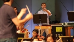 Miles Salerni plays the triangle during a rehearsal of Wagner's 'Seigfried's Rhine Journey' with the Tanglewood Music Center Orchestra.