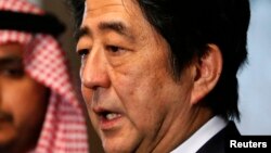 Japan's Prime Minister Shinzo Abe speaks to reporters after signing a condolences book as he pays his respect for Saudi Arabia's King Abdullah, during a visit to the Royal Embassy of the Saudi Arabia in Tokyo, Jan. 25, 2015. 
