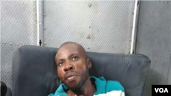 Arnel Joseph dressed and on a stretcher. UN helicopter prepares to transfer him to Port au Prince.