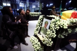 Relatives mourn in front of the coffin of the country’s Army Chief of Staff Seare Mekonnen, who was shot by his bodyguard, during a memorial ceremony in Addis Ababa, June 25, 2019.