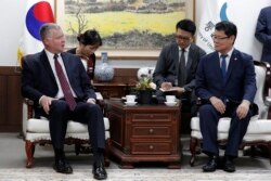 South Korean Unification Minister Kim Yeon Chul, right, and U.S. Special Representative for North Korea Stephen Biegun, left, talk during their meeting at a government complex in downtown Seoul, South Korea, Aug. 21, 2019.