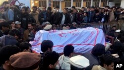FILE - Pakistanis attend a funeral service for the victims of a bomb blast at a mosque in Parachinar, the capital of Pakistan's northwestern Kurram tribal region, Jan. 21, 2017. 
