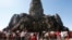 In this Sunday, Dec. 31, 2017, photo, tourists line up for stepping up Angkor Wat temple outside Siem Reap, Cambodia. Tourists celebrated New Year at Angkor Wat temple where is Cambodia's main tourist destination. The temples, built between the 9th and 15th centuries. (AP Photo/Heng Sinith)