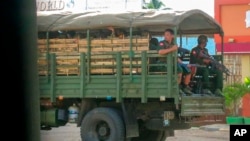 FILE - Military troops and police go on patrol at Kayah state, eastern Myanmar, May 23, 2021. 