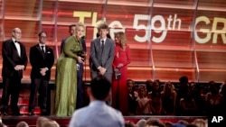 FILE- Adele accepts the award for record of the year for "Hello" at the 59th annual Grammy Awards, Feb. 12, 2017, in Los Angeles. 